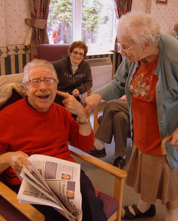 A group of care home residents doing a drama role play activity.
