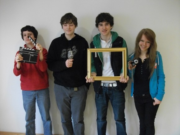 Four young people from a media project.